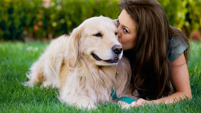 Woman kissing dog