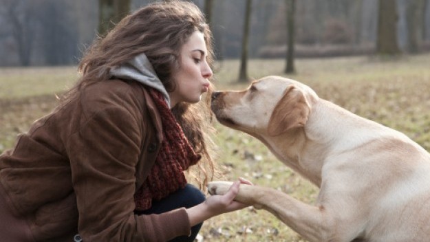 Woman kissing dog e1384278451927